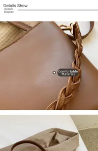 Détail du sac seau en cuir marron avec bandoulière tressée et boucles en métal doré