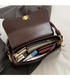 Detail view of large dark brown retro shoulder bag with spacious interior compartments