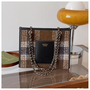 Detailed shot of brown plaid woolen tote bag with dual chain straps and leather pocket