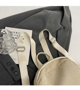 Detail of light beige corduroy backpack showing smooth adjustable nylon shoulder straps