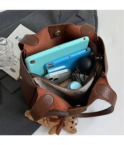 Top view of spacious brown leather bucket bag showing large capacity for daily essentials