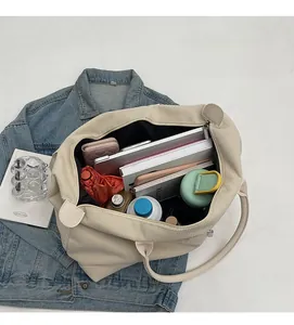 Spacious beige corduroy tote interior showing laptop, books and travel essentials