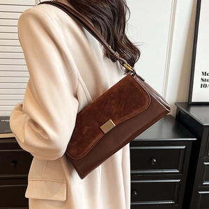 Retro dark brown frosted leather underarm bag with gold buckle shown from a side view