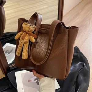 Large capacity brown pebbled leather tote bag with a cute knitted bear charm and twin handles