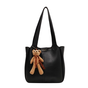 Black litchi grain leather tote bag with stylish bear pendant and golden logo