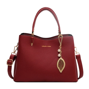Elegant red leather wedding handbag with pearl leaf charm and gold hardware detail