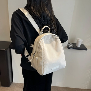 Minimalist cream corduroy backpack with large capacity shown from a back perspective