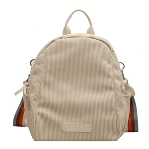 Minimalist cream corduroy backpack featuring colorful striped straps and large capacity