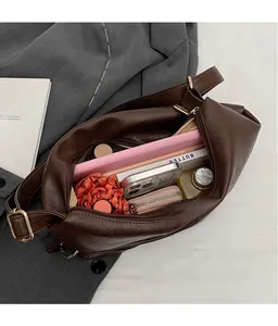 Top view of spacious dark brown faux leather tote bag with gold buckle for daily commute