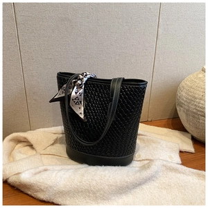 Detail of black woven tote bag with contrast stitching and decorative silk scarf