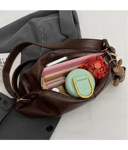 Close-up showing large capacity interior of dark brown soft leather crossbody bag