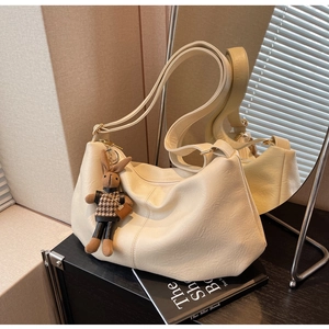 Detail of soft cream PU leather pleated dumpling bag with cute rabbit plush charm