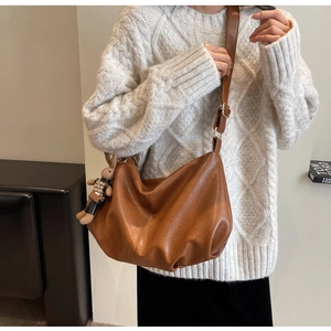 Brown pleated hobo shoulder bag styled with an autumn white sweater and cute rabbit charm