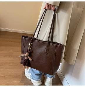 Brown vintage tote bag with lychee texture and cute rabbit charm for casual daily wear