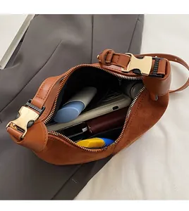 Interior view showing the large capacity and matte suede texture of the crescent bag