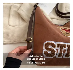 Detail view of the adjustable brown leather strap on a vintage frosted tote bag