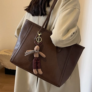 Large dark brown faux leather tote bag with rabbit charm and minimalist design