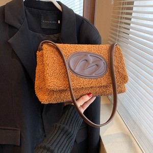 Caramel faux fur crossbody bag with leather strap and embossed M letter logo