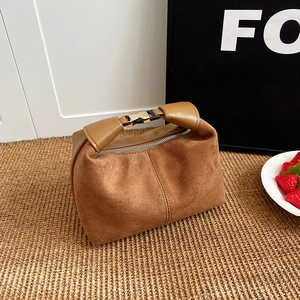 Minimalist brown suede crescent bag with leather handle and gold buckle detail