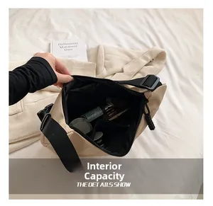 Detail showing internal capacity of beige nylon crossbody bag with interior pockets