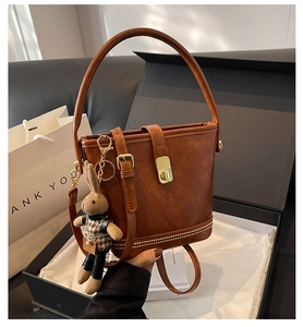 Sac seau en simili cuir marron avec rivets et charm lapin dans une boîte cadeau élégante