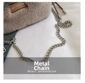 Detail of the brown plush bucket bag showing hardware chain and love every day leather tag