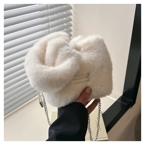 Detailed shot of white faux fur knot handbag with elegant silver metal chain strap