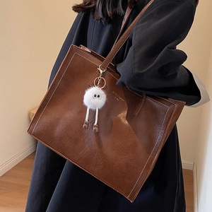 Grand sac cabas marron rétro avec surpiqûres contrastées et pendentif en peluche blanc