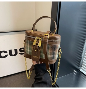 Detail of vintage plaid box bag with gold chain strap and leather handle