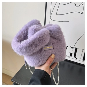 Detail of soft purple plush faux fur bucket bag featuring a silver metal chain strap