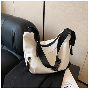 Detail of white nylon crescent bag with contrast black wide strap and buckle