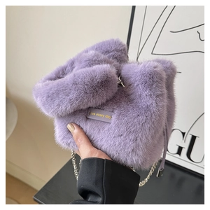 Detailed close-up of soft purple faux fur handbag with Love Every Day leather patch
