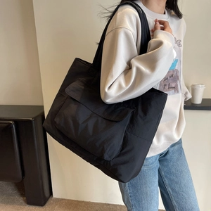 Minimalist black large capacity nylon tote bag with front pocket for casual commute