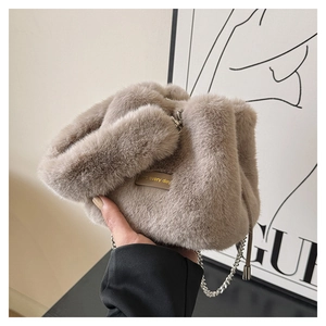 Close-up of light khaki plush bucket bag with metal chain and love every day leather tag