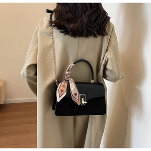Detail of black PU crossbody bag with golden twist lock and heart pattern silk scarf