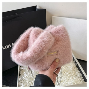 Detailed close-up of pink fluffy bucket bag featuring a have every day gold stamp tag
