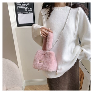 Detail showing soft pink faux fur texture and silver metal chain strap on bucket bag