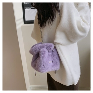 Detail shot of plush purple faux fur bucket bag with silver metal chain shoulder strap