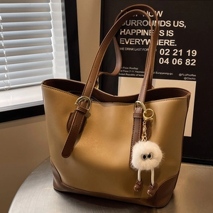 Large capacity bicolor leather tote bag in beige and brown with cute plush charm