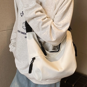 White nylon dumpling crossbody bag with adjustable black shoulder strap for women