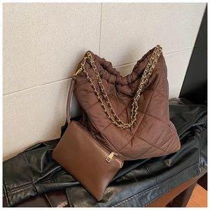Détail du sac fourre-tout matelassé marron avec chaîne dorée et pochette assortie