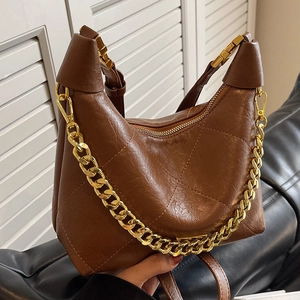 Brown oil wax leather dumpling bag with diamond quilting and gold chain strap