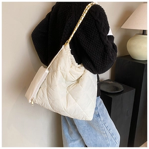 Détail du sac bandoulière blanc matelassé avec chaîne dorée et petite pochette assortie
