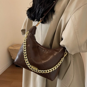 Quilted dark brown half-moon crossbody bag with chunky gold chain and leather strap