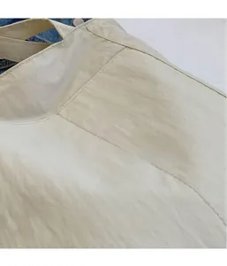 Close-up of lightweight off-white nylon fabric showing fine texture and soft wrinkles