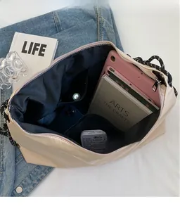 Interior view of beige Oxford tote bag showing spacious compartments and zip closure