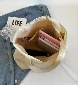 Interior view of beige nylon tote bag with zipper pocket and spacious main compartment
