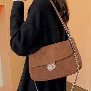 Brown quilted suede shoulder bag with silver chain strap and metal turn-lock closure