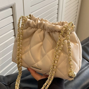 Beige quilted leather bucket bag with gold chain strap and drawstring closure