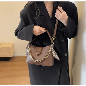 Brown lychee leather crossbody bag detailed with geometric silk scarf and gold chain